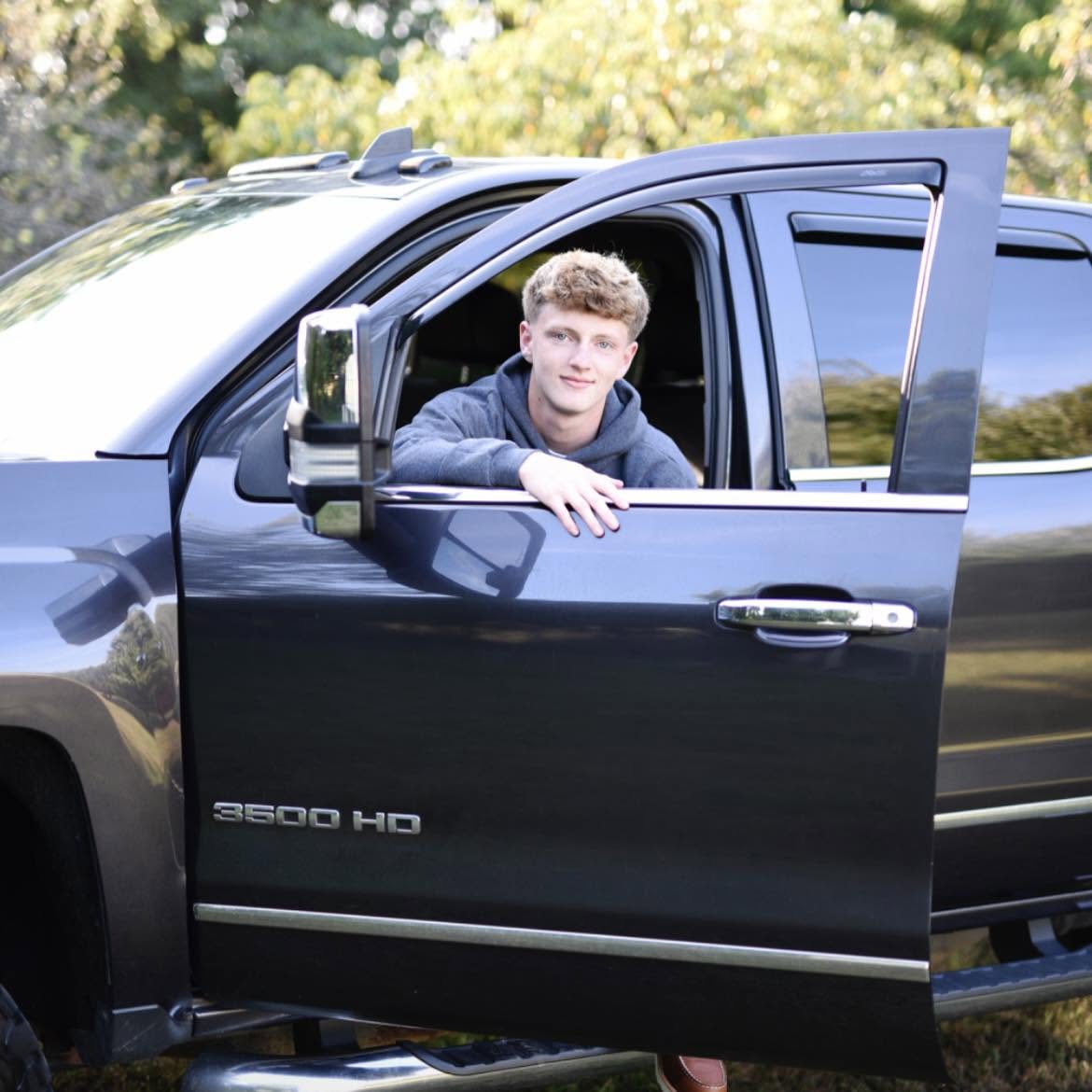Payton Maas, owner of Be There Lawncare, with his work truck
