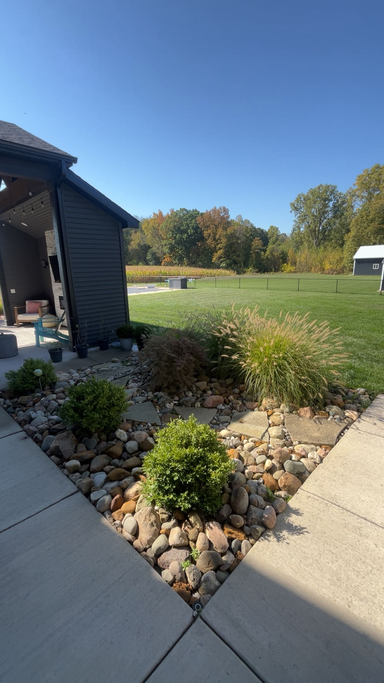 Rock bed landscaping with ornamental grasses — Be There Lawncare Haslett MI