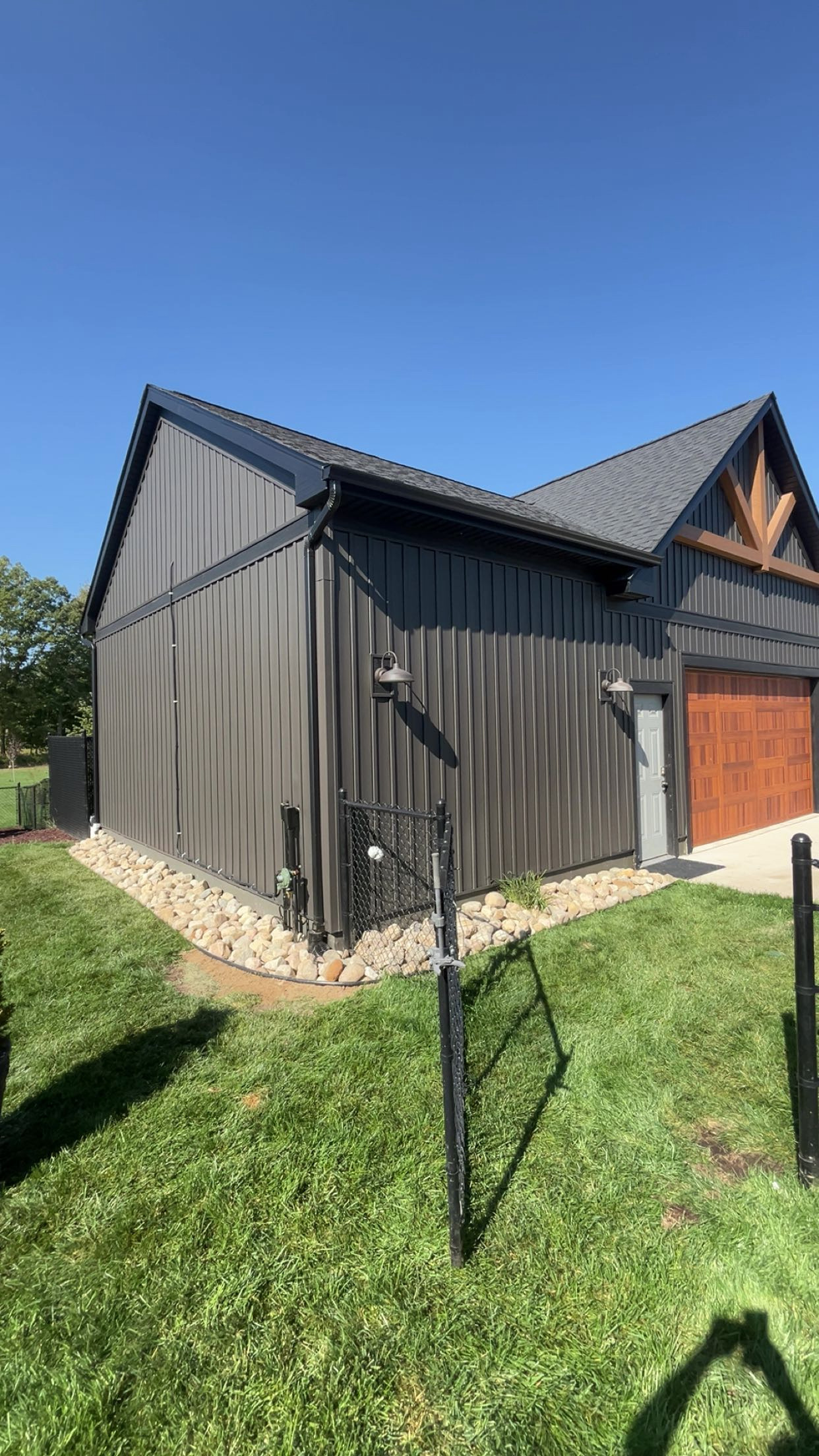 Barn foundation landscaping with river rock — Haslett Michigan